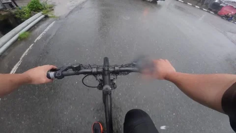 POV Riding a Bicycle in the Rain Stock Footage 337903644