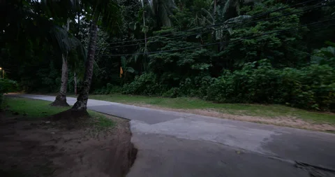 POV riding from side way to central road of Juara village at Tioman Island Stock Footage 314770896