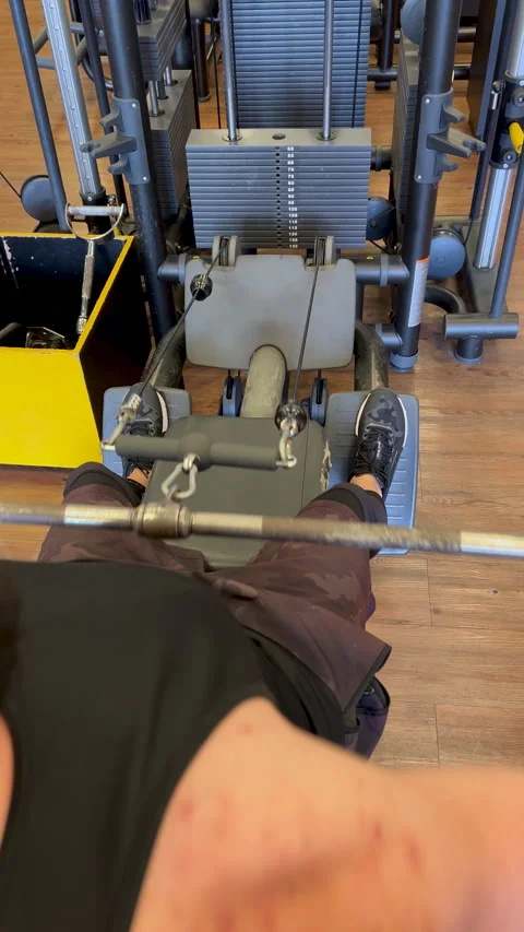 POV seated cable row feet on platform - first person gym back training vertical Stock Footage 337381162