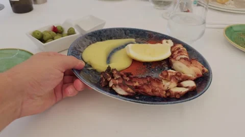 POV serving grilled octopus with mashed potatoes at restaurant Video stock 321193209