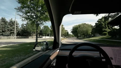POV shoot of inside an electric vehicle driving through a suburban street Stock Footage 340450718