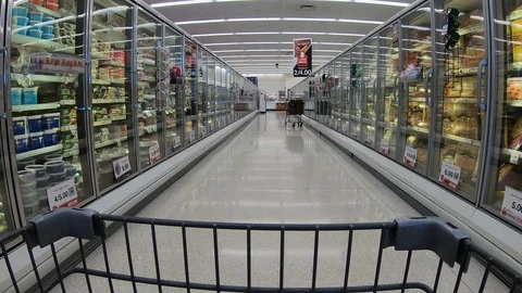 POV from the shopping cart while going past the frozen food freezers Stock Footage 122094765