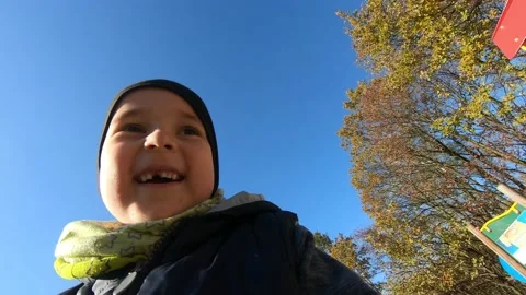 POV shot of boy having fun while riding down slide in playground at sunny day Stock Footage 131065193