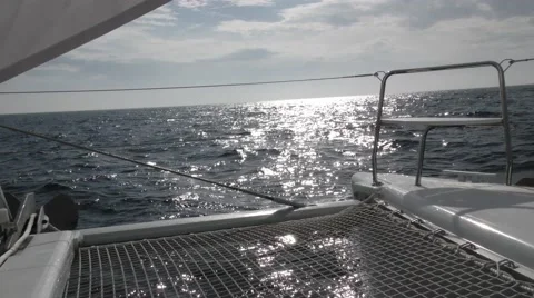 POV shot on catamaran as it cuts through waves under full sail Stock Footage 67864013