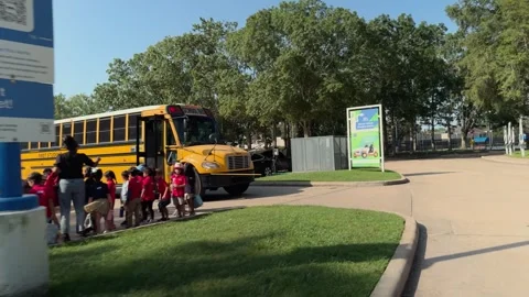 A POV shot of children lining up after exiting the school bus before entering Stock-Footage 341360880