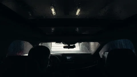 POV shot of Driver inside vehicle entering automatic car wash with visible Stock Footage 332183530