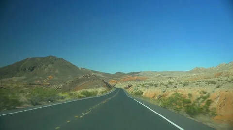 POV shot - driving on a desolate desert highway Stock Footage 61877804