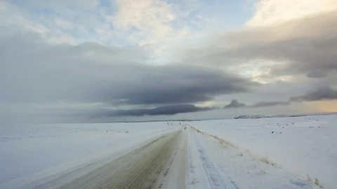 POV shot driving on ice and snow over a frozen ground in a country road Stock Footage 93402663