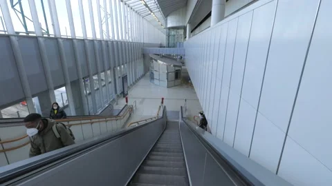 POV shot going down the escalator in modern airport terminal Stock Footage 165358773