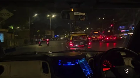 POV shot inside a car driving on the illuminated streets of Mumbai, India, night Stock Footage 309745071
