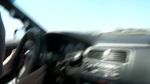 A POV shot from inside a car as a test driver on track takes it through Stock Footage 107478424