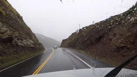 POV shot inside an RV driving through the coast of California on a rainy Stock Footage 113014287