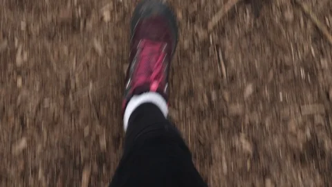 POV shot looking down at feet walking in slow motion Stock Footage 127623399