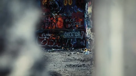 POV shot looking through a crack in the wall into a creepy abandoned building. Stock Footage 249891762