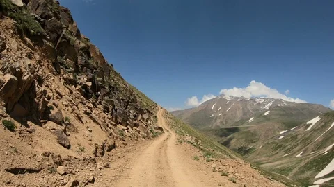 A POV shot of a mountain dirt path high on mountain peaks Stock Footage 118064482