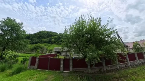 POV shot from a moving car window passing traditional rural village houses with Vídeo Stock 346181065