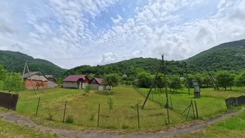 POV shot from a moving car window passing traditional rural village houses with Vídeo Stock 346181127