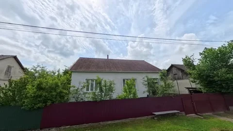 POV shot from a moving car window passing traditional rural village houses with Vídeo Stock 346181228