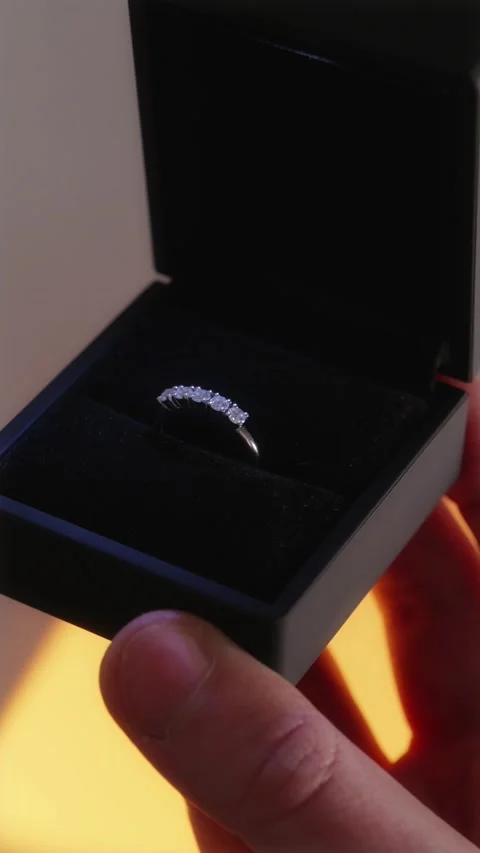 POV shot of a person looking at a five diamond ring in a black matte box Stock Footage 334549366