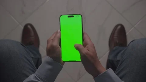 POV shot of Person Using Smartphone with Green Screen while seated. Stock Footage 279106486