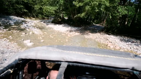 POV shot riding by offroad and mountain river with stones on buggy car Stock Footage 145841953