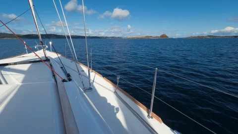 POV shot. Someone is standing on the deck of a beautiful white yacht enjoying a Stock Footage 87561288