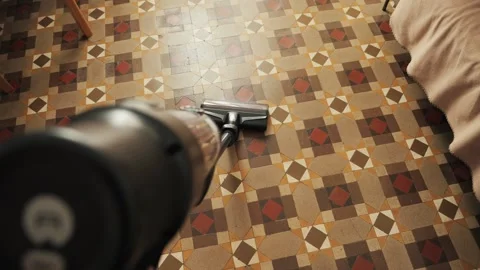 Pov shot of vertical vacuum cleaner with LED light used on floor. Close-up of Stock Footage 314557657