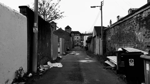 A pov shot of walking down an access road between old houses. Stock Footage 171832213