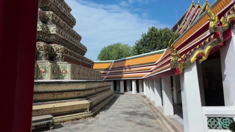 POV shot walking through a gate and tilting up to a large ornamental pagoda at Stock Footage 303402514