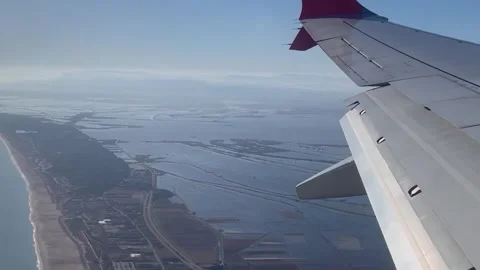 POV shot from window plane with view of the wing with Albufera Stock Footage 262475032