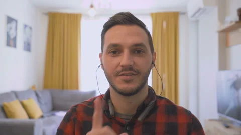 POV shot of young man working from home with earphones and webcam Video stock 143137356