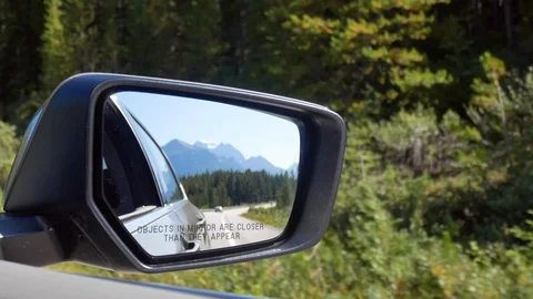 POV of side mirror of the moving car while driving on local road in canada Stock Footage 120020920
