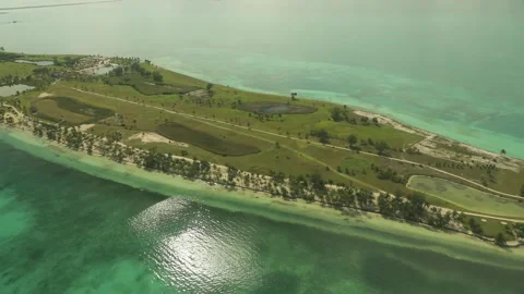 POV side view from airplane taking off from small Caribbean island green runway Stock Footage 204927402