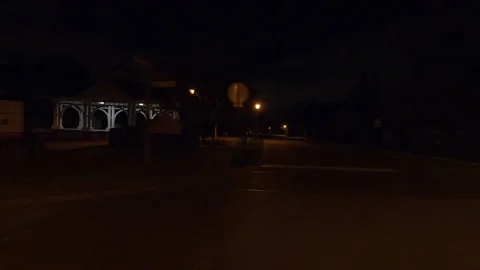 POV side view driving in car traffic on a very dark night on city streets Stock Footage 162021630