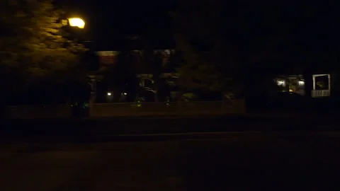 POV side view driving in car traffic on a very dark night on city streets Stock Footage 162021913