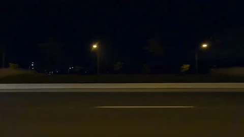 POV side view driving in car traffic on a very dark night on city streets Stock Footage 162046959