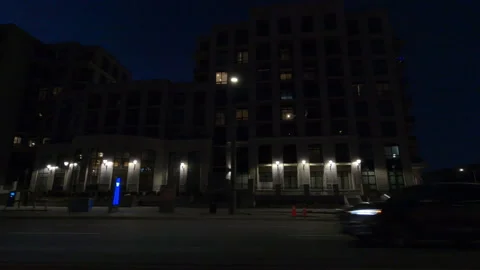 POV side view driving at night on dark city street 库存影片 144088095