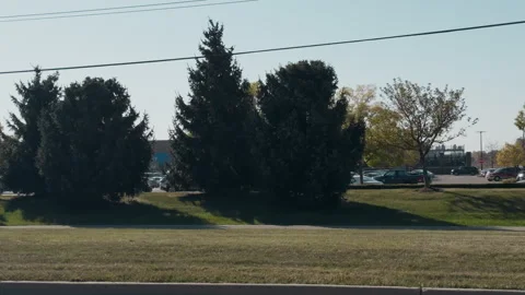 POV side view from moving car at Walmart store with a bustling parking Stock Footage 304405386