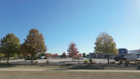 POV side view from moving car of Lowe's hardware store with a bustling Stock Footage 304469987