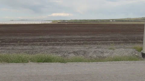POV side view rich soil and farmland in the Holland marsh of Ontario Video stock 154331854