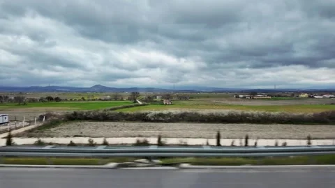 POV Side Window View of Moving Car Passing Green Rural Fields and Countryside 動画素材 334201257