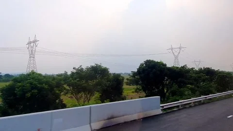 POV of sightseeing a landscape through the window from inside a moving bus .. Stock Footage 295138231