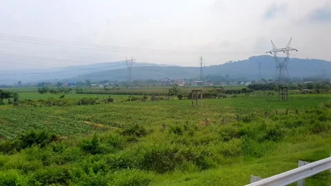 POV of sightseeing a landscape through the window from inside a moving bus .. Stock Footage 295138233