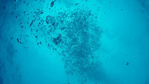 POV of sinking deep under water with bubbles streaming upwards Stock Footage 97940654