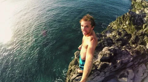 POV Slow Motion Sunset Cliff Jumping. Athletic Young Man Jumping From Cliff I Video stock 57223720