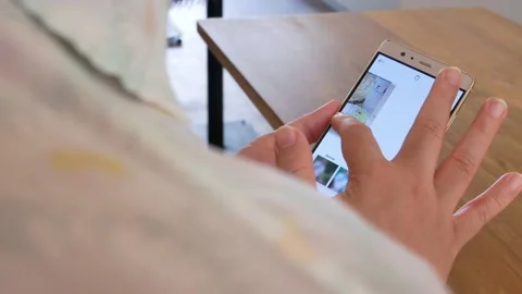 POV to a smartphone mobile while a finger touching on mobile phone. Stock Footage 130328134