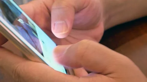 POV to a smartphone mobile while a finger touching on mobile phone. Stock Footage 130328381