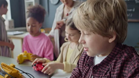 POV of Smiling Boy Presenting Robot during Stem Lesson Stock Footage 339205833