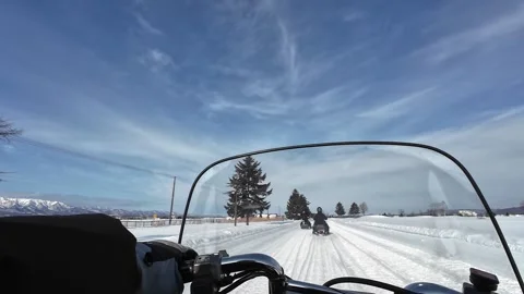 POV snowmobile approaching large tree with riders in snowy field Hokkaido Vídeos de archivo 333230170