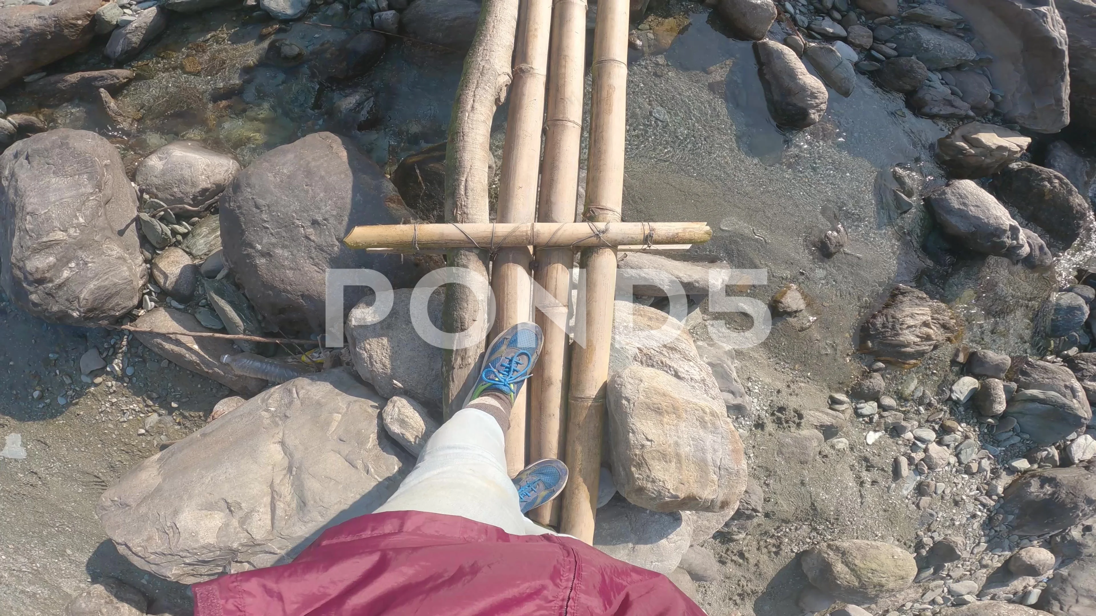 POV of a solo female traveler crossing the river through two narrow bridge.